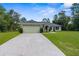 Single Gathering home with a well manicured lawn, lush landscaping, and a two-car garage at 10197 Meadow Wren Ave, Weeki Wachee, FL 34613