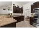 Well-appointed kitchen with dark cabinetry, stainless steel appliances, and bright countertops at 10197 Meadow Wren Ave, Weeki Wachee, FL 34613