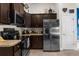 Modern kitchen with stainless steel appliances, stone countertops, and ample cabinet space at 10197 Meadow Wren Ave, Weeki Wachee, FL 34613