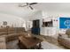 Open-concept living room flows into the kitchen, featuring stylish furniture and a welcoming atmosphere at 10197 Meadow Wren Ave, Weeki Wachee, FL 34613