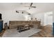 Comfortable sectional sofa and rustic coffee table in a bright, inviting living space with vaulted ceiling at 10197 Meadow Wren Ave, Weeki Wachee, FL 34613