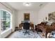 A well-lit home office featuring elegant wooden desks, comfortable seating, and a large window for natural light at 10197 Meadow Wren Ave, Weeki Wachee, FL 34613