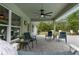 Covered patio features a ceiling fan, brick flooring and an outdoor seating area at 10197 Meadow Wren Ave, Weeki Wachee, FL 34613