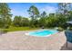 Outdoor pool area featuring lush greenery and comfortable seating, creating a serene retreat at 10197 Meadow Wren Ave, Weeki Wachee, FL 34613