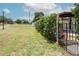 Well-maintained backyard with mature trees and manicured bushes by the house, with access to a public park at 10325 Parkcrest Dr, Tampa, FL 33624