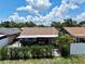 An aerial shot of a home with a covered patio, privacy fence, and well-manicured hedges at 10325 Parkcrest Dr, Tampa, FL 33624