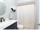 Stylish bathroom with a modern vanity, round mirror, and a shower with a patterned curtain at 10325 Parkcrest Dr, Tampa, FL 33624