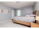 Bright bedroom features a wooden bed frame, tiled floors, and natural light at 10325 Parkcrest Dr, Tampa, FL 33624