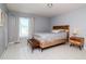 Comfortable bedroom features a stylish bed frame and bench with tiled flooring at 10325 Parkcrest Dr, Tampa, FL 33624