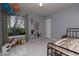 Bright bedroom with tile flooring, neutral walls, closet and window with light-blocking curtains at 10325 Parkcrest Dr, Tampa, FL 33624