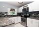 Updated kitchen features modern appliances, tiled backsplash and granite countertops at 10325 Parkcrest Dr, Tampa, FL 33624