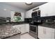 Updated kitchen features modern appliances, tiled backsplash and granite countertops at 10325 Parkcrest Dr, Tampa, FL 33624