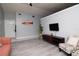 Bright living room featuring hardwood floors, gray walls, and contemporary furniture at 10325 Parkcrest Dr, Tampa, FL 33624