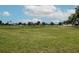 Expansive community park with playground, green space, and walking path under a bright blue sky with clouds at 10325 Parkcrest Dr, Tampa, FL 33624