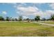 Expansive community park with playground, green space, and walking path under a bright blue sky with clouds at 10325 Parkcrest Dr, Tampa, FL 33624