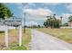 Entrance to a Residents Park with walking path and mature palm trees at 10325 Parkcrest Dr, Tampa, FL 33624