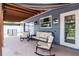 Relaxing covered patio with rocking chairs and comfortable seating, ideal for enjoying the outdoors at 10325 Parkcrest Dr, Tampa, FL 33624