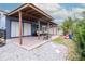 Inviting covered patio with neutral furniture, a slide, and rock garden, perfect for outdoor entertaining at 10325 Parkcrest Dr, Tampa, FL 33624