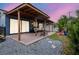 Inviting covered patio with neutral furniture, a slide, and rock garden, perfect for outdoor entertaining at 10325 Parkcrest Dr, Tampa, FL 33624