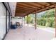 Large covered patio with ample space for entertaining, featuring a glimpse of the surrounding greenery at 10325 Parkcrest Dr, Tampa, FL 33624