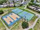 Aerial view of well-maintained tennis and basketball courts in the community at 10325 Parkcrest Dr, Tampa, FL 33624