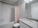 Bathroom featuring a tub with shower, toilet, and vanity with gray countertops and white cabinets at 10464 Tranquil Meadow Loop, Riverview, FL 33569