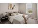 Comfortable bedroom with a large window, neutral decor, and stylish contemporary artwork above the headboard at 10464 Tranquil Meadow Loop, Riverview, FL 33569