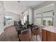 Bright dining area with a modern black table, stylish chairs, and abundant natural light at 10464 Tranquil Meadow Loop, Riverview, FL 33569