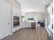 Well-lit kitchen featuring stainless steel appliances, white cabinetry, and stylish backsplash at 10464 Tranquil Meadow Loop, Riverview, FL 33569