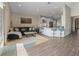 Open-concept living room with a modern blue sofa and adjacent kitchen with a breakfast bar at 10464 Tranquil Meadow Loop, Riverview, FL 33569