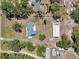 Aerial view of a property featuring a single-Gathering home, a large metal workshop, and a landscaped yard at 10722 Sumner Rd, Wimauma, FL 33598