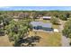 Aerial view of the home showcasing its expansive lot and mature trees at 10722 Sumner Rd, Wimauma, FL 33598