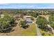 Aerial view of a home with mature trees, a long driveway, and a large backyard at 10722 Sumner Rd, Wimauma, FL 33598