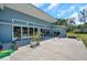Spacious backyard patio featuring modern sliding glass doors, perfect for outdoor entertaining at 10722 Sumner Rd, Wimauma, FL 33598