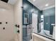 Sleek bathroom with a frameless glass shower, rainfall shower head, and elegant fixtures at 10722 Sumner Rd, Wimauma, FL 33598