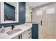 Modern bathroom featuring a glass shower, quartz countertops, and striking blue accent wall at 10722 Sumner Rd, Wimauma, FL 33598