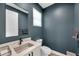 Modern half bathroom with a sleek vanity, contemporary fixtures, and stylish decor at 10722 Sumner Rd, Wimauma, FL 33598