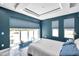 Well-lit bedroom with large windows, exercise equipment, and modern decor at 10722 Sumner Rd, Wimauma, FL 33598