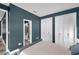 Bedroom showcases blue accent walls, two windows, two large closets, and custom floor at 10722 Sumner Rd, Wimauma, FL 33598