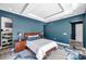 Spacious primary bedroom with tray ceiling, stylish rug, and decorative floor design at 10722 Sumner Rd, Wimauma, FL 33598