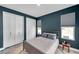 Cozy bedroom with plush pillows, natural lighting, and two closet doors at 10722 Sumner Rd, Wimauma, FL 33598