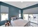 Well-lit bedroom with a view of the backyard, comfortable bedding, and stylish window treatments at 10722 Sumner Rd, Wimauma, FL 33598