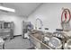 Commercial kitchen featuring stainless steel sinks, sanitizer station, and professional-grade dishwashing equipment at 10722 Sumner Rd, Wimauma, FL 33598