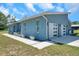 Stylish single-story home featuring a two-car garage and well-maintained landscaping along the walkway at 10722 Sumner Rd, Wimauma, FL 33598