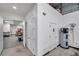 Hallway with storage, utilities, and access to kitchen area at 10722 Sumner Rd, Wimauma, FL 33598