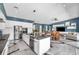 Large open kitchen with a spacious island, stainless steel appliances, and connected dining and living spaces at 10722 Sumner Rd, Wimauma, FL 33598