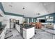 Contemporary kitchen featuring a center island, stainless appliances, and an open flow to dining and living areas at 10722 Sumner Rd, Wimauma, FL 33598