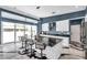 Modern kitchen with white cabinets, black marble countertops, and a large island with seating at 10722 Sumner Rd, Wimauma, FL 33598