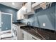Well-equipped laundry room featuring modern machines and striking black marble countertops at 10722 Sumner Rd, Wimauma, FL 33598