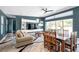 Spacious living room with modern decor, large windows, and hardwood floors at 10722 Sumner Rd, Wimauma, FL 33598